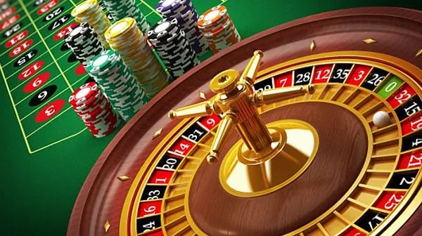 A live casino dealer distributing cards at a baccarat table.